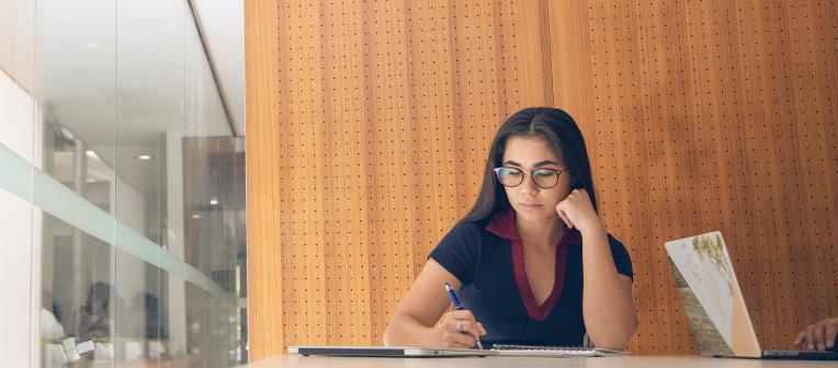 Universities Accepting SAT Scores of 1500 to 1600 - Girl writing something